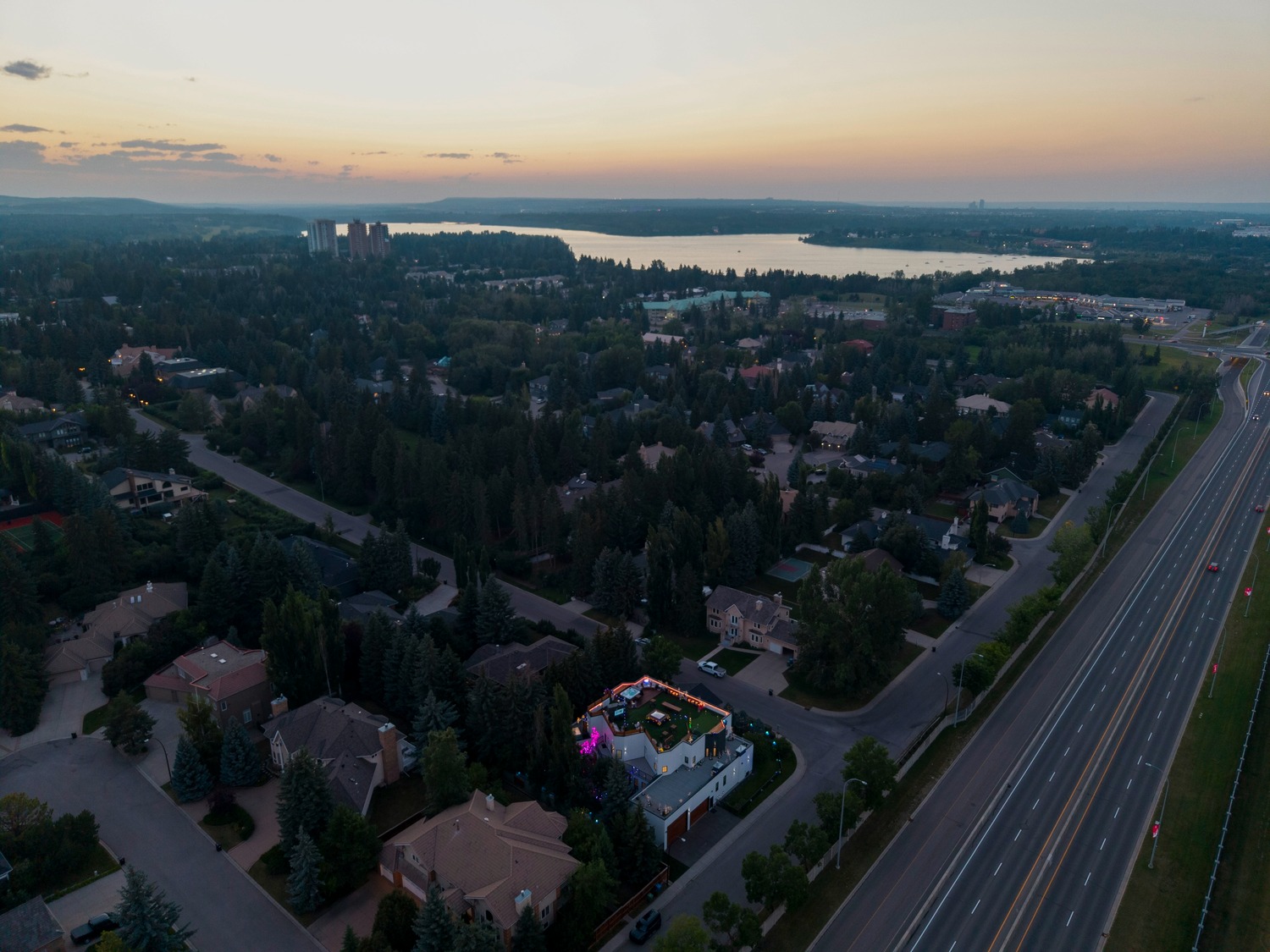 Pump Hill at sunset — estate streets, the Glenmore Reservoir on the horizon